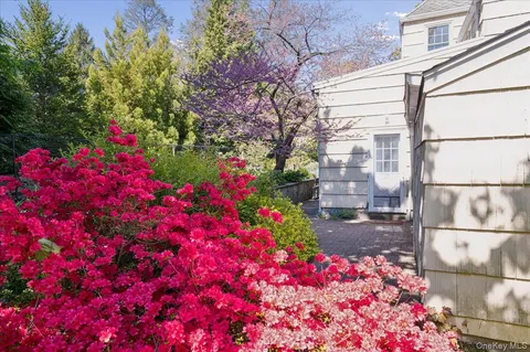 a flower garden in front of a house