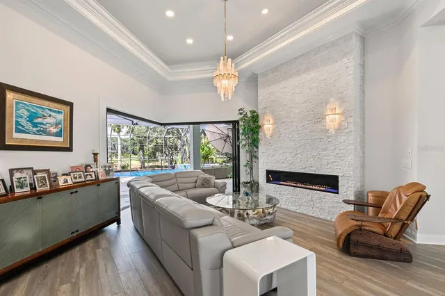 a dining room with furniture and a floor to ceiling window