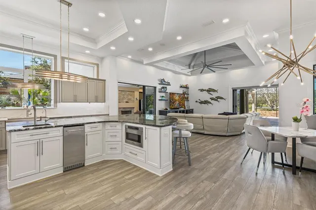 a bathroom with a granite countertop sink a toilet and shower