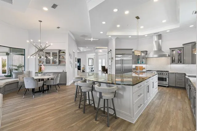 a spacious bedroom with a bed and a flat screen tv