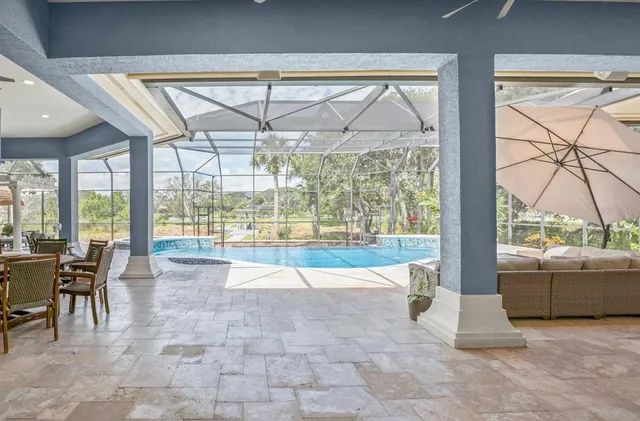 an aerial view of residential houses with outdoor space and lake view