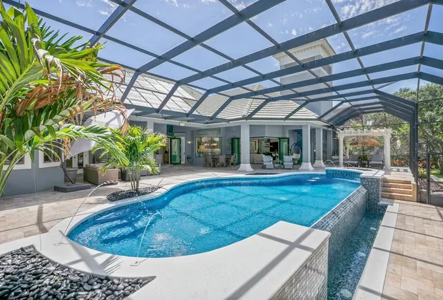 an aerial view of a house with a yard and lake view