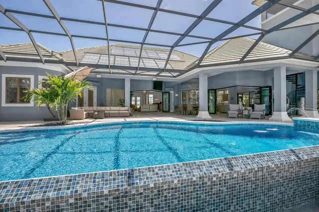 a front view of a house with a garden and lake view