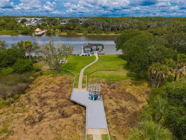 an aerial view of a city with lots of residential buildings and mountain view in back