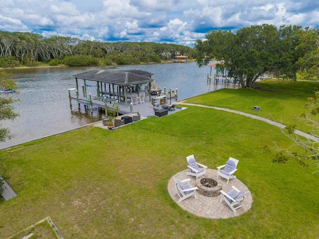 an aerial view of a house with swimming pool garden view and city view