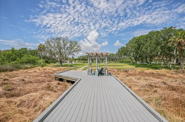 a media room with lots of chairs and a chandelier