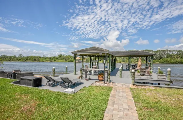 a view of a golf ground with huge green field and large trees