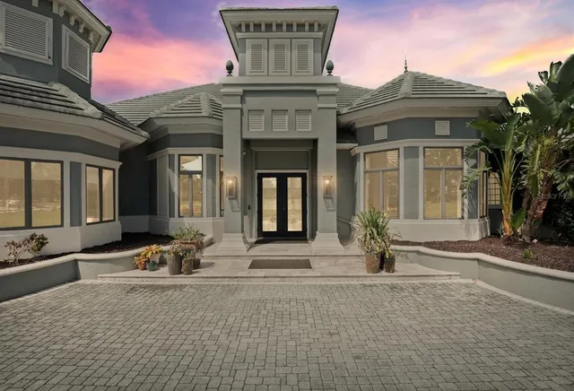 a view of a dining room with furniture and a chandelier