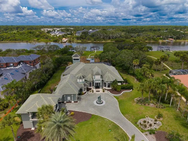 a kitchen with stainless steel appliances granite countertop a stove top oven a sink dishwasher a dining table and chairs with wooden floor