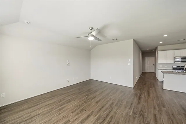 a view of a kitchen with wooden floor and a sink