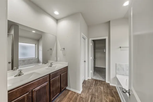 a spacious bathroom with a double vanity sink and a mirror