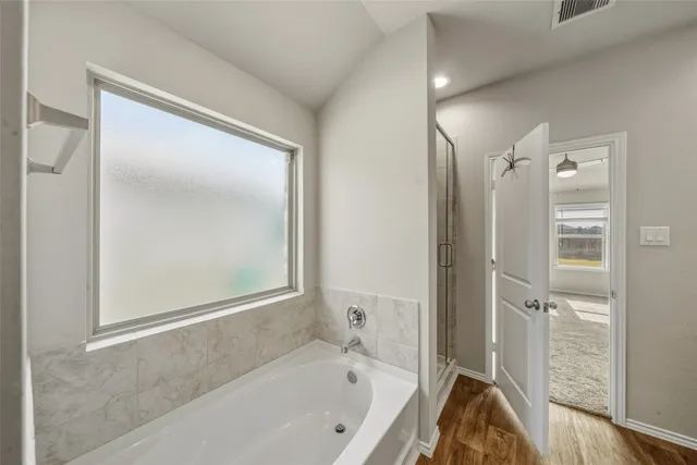 a bathroom with a bathtub and a shower