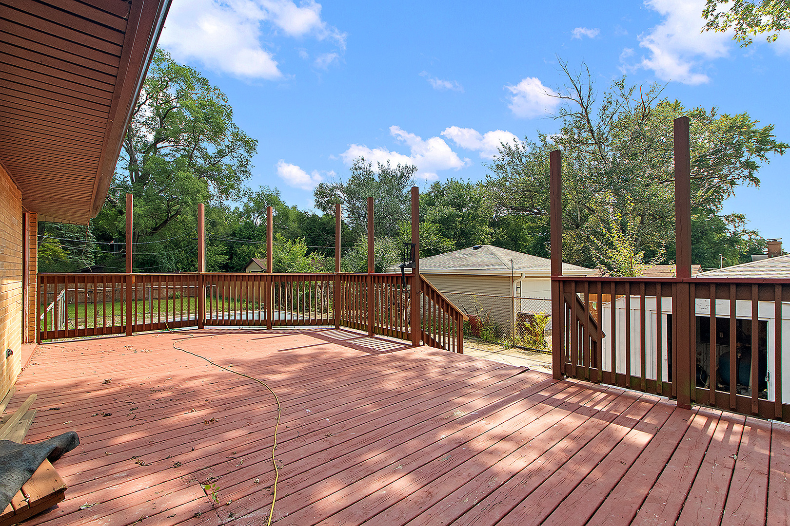 1400 Eunice Avenue Joliet, IL 60433 - Photo 21 of 34 a view of a deck with wooden floor and fence with a large tree