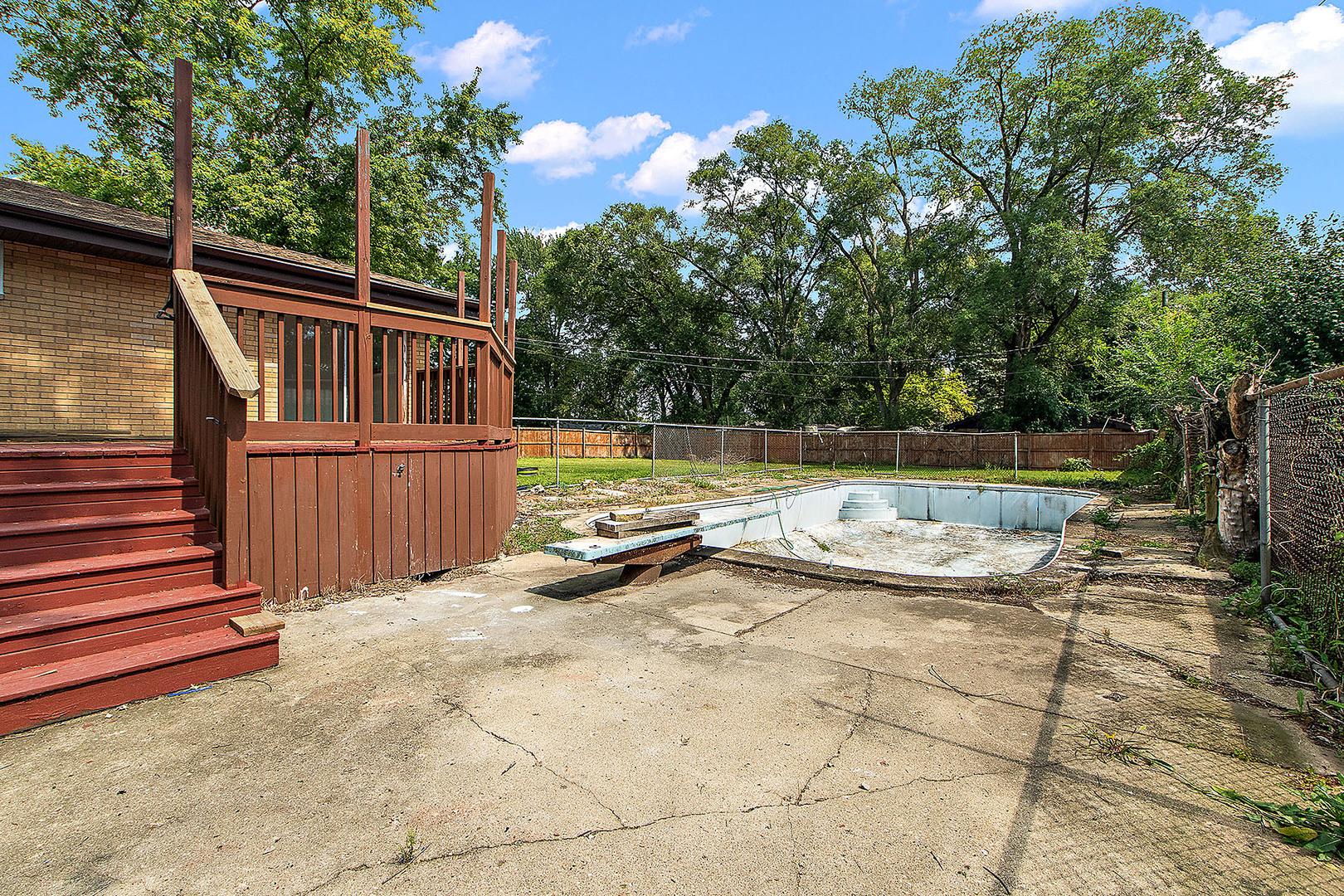 1400 Eunice Avenue Joliet, IL 60433 - Photo 22 of 34 a view of a backyard with wooden fence and large trees