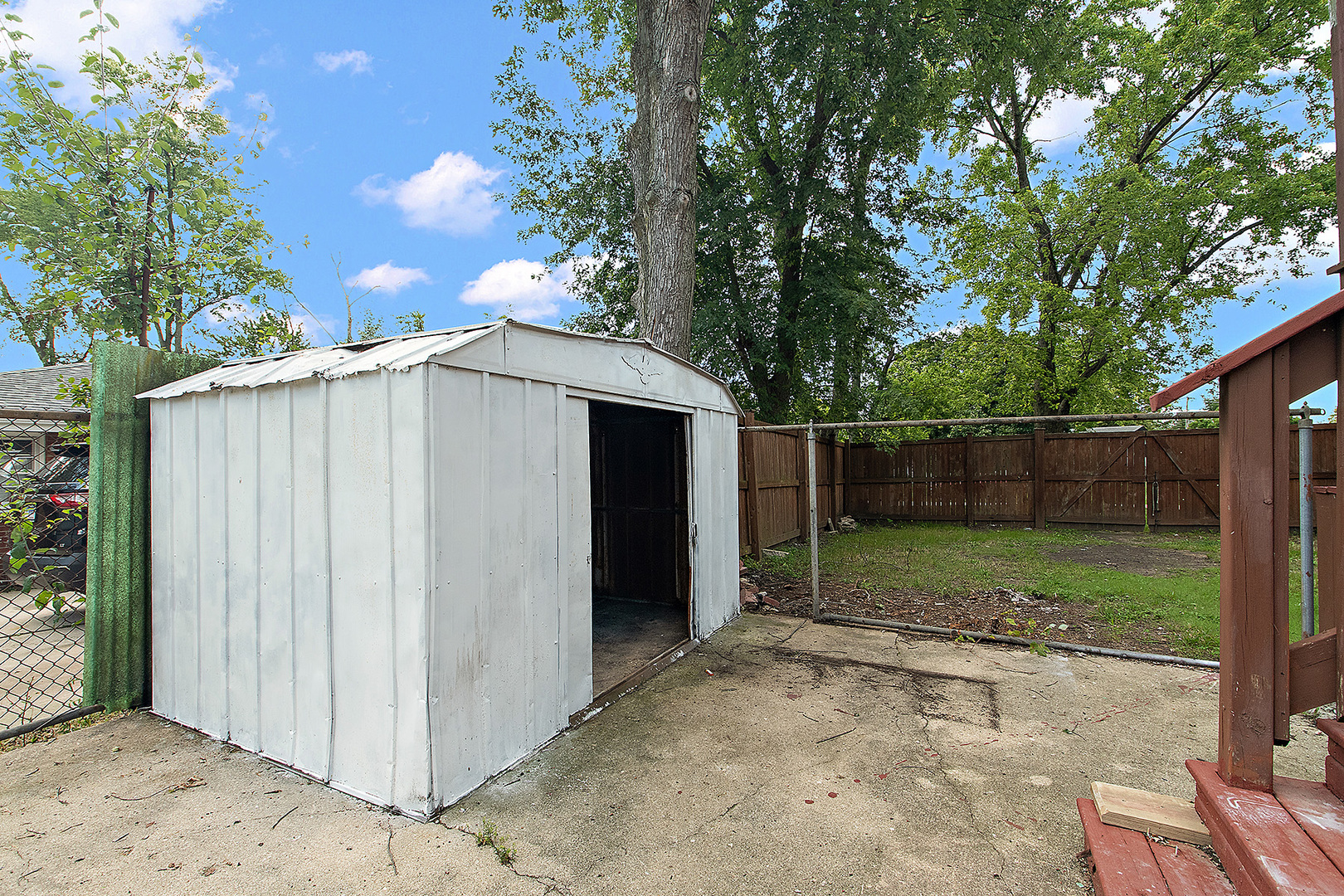 1400 Eunice Avenue Joliet, IL 60433 - Photo 24 of 34 a view of a backyard with large trees and wooden fence