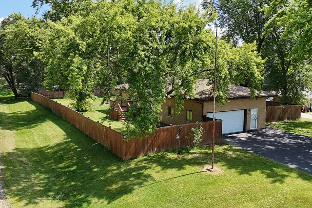 a view of a backyard with a tree