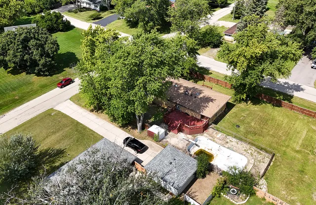 an aerial view of a house with a yard