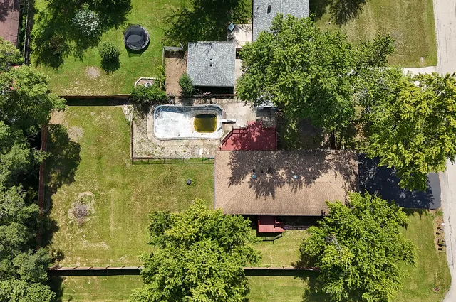 an aerial view of a house with garden space sitting space and swimming pool