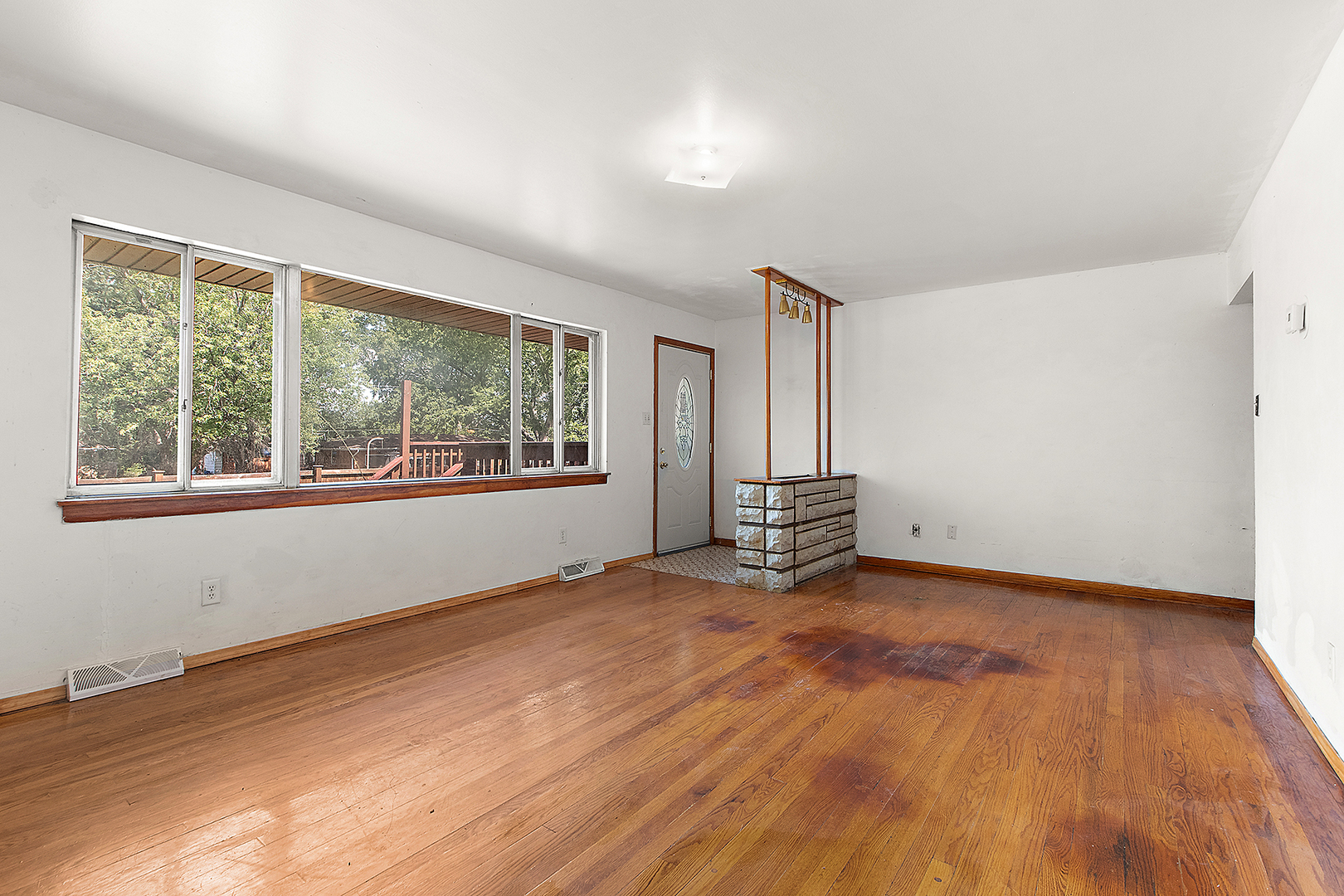 1400 Eunice Avenue Joliet, IL 60433 - Photo 4 of 34 a view of an empty room with wooden floor and a window