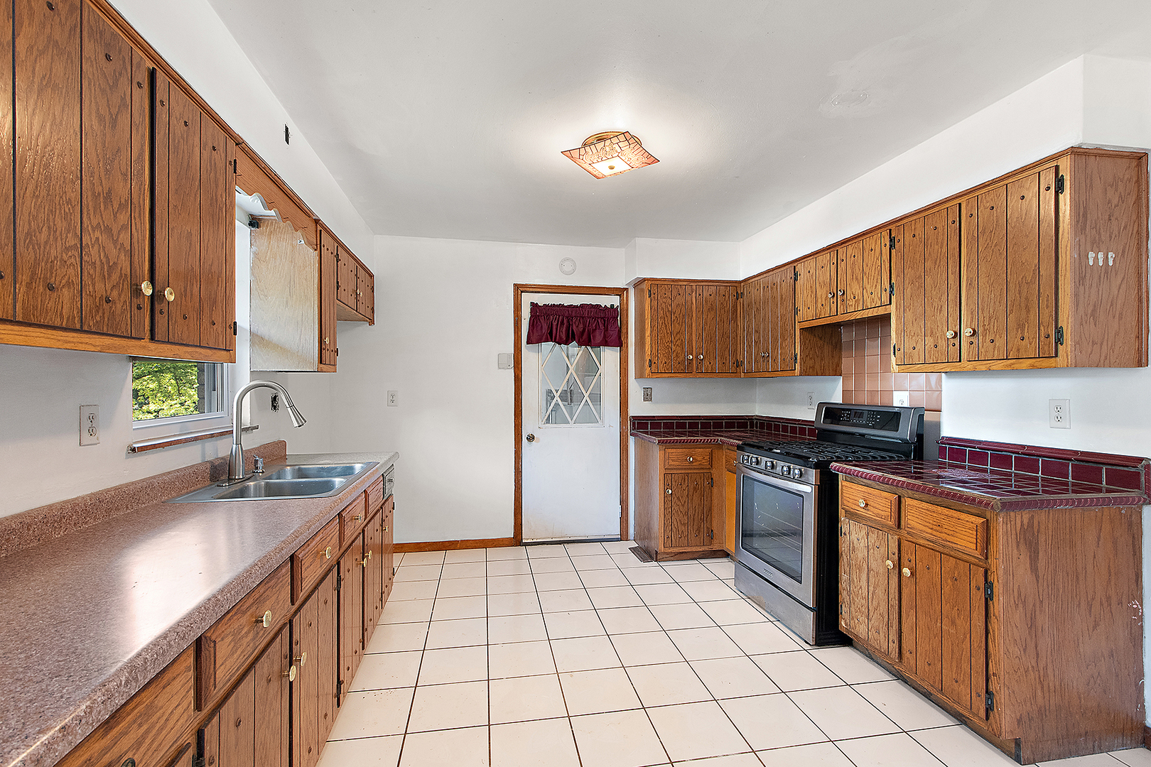1400 Eunice Avenue Joliet, IL 60433 - Photo 5 of 34 a kitchen with stainless steel appliances granite countertop a sink stove and cabinets