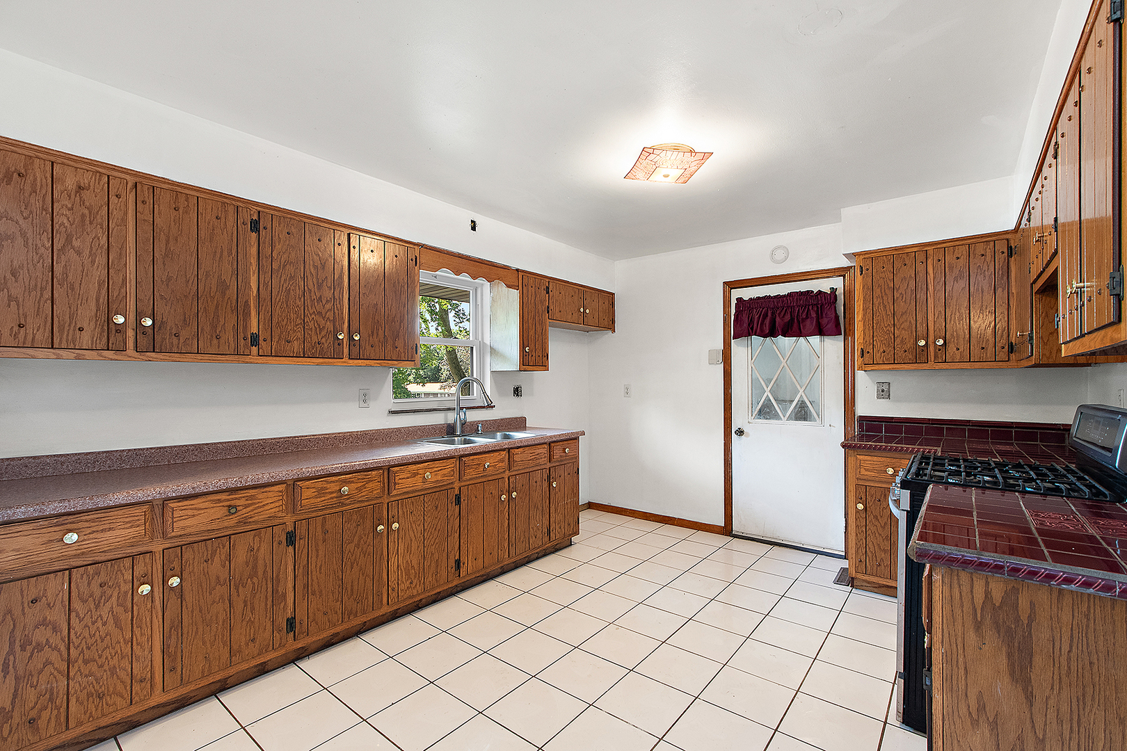 1400 Eunice Avenue Joliet, IL 60433 - Photo 6 of 34 a kitchen with sink a refrigerator and cabinets