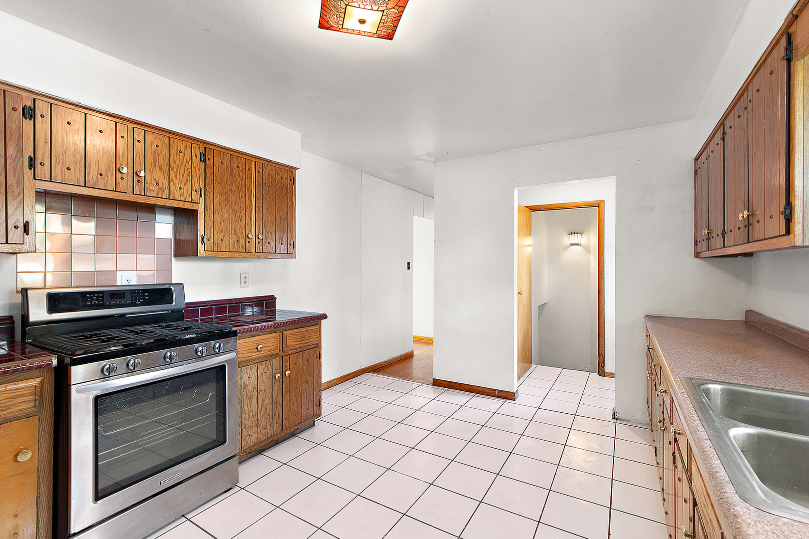 1400 Eunice Avenue Joliet, IL 60433 - Photo 7 of 34 a kitchen with stainless steel appliances granite countertop a stove a sink and a refrigerator
