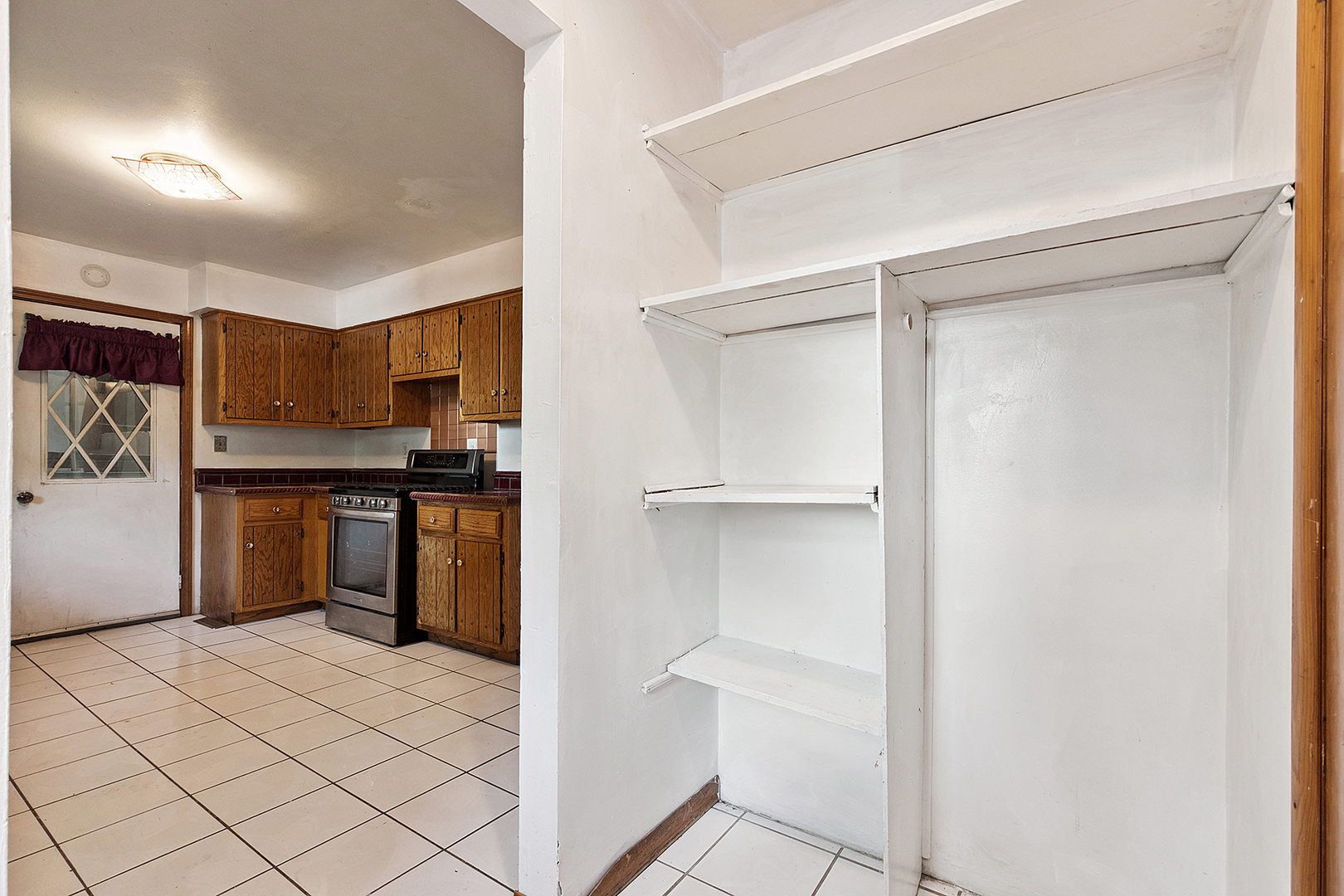 1400 Eunice Avenue Joliet, IL 60433 - Photo 8 of 34 a kitchen with a refrigerator and white cabinets