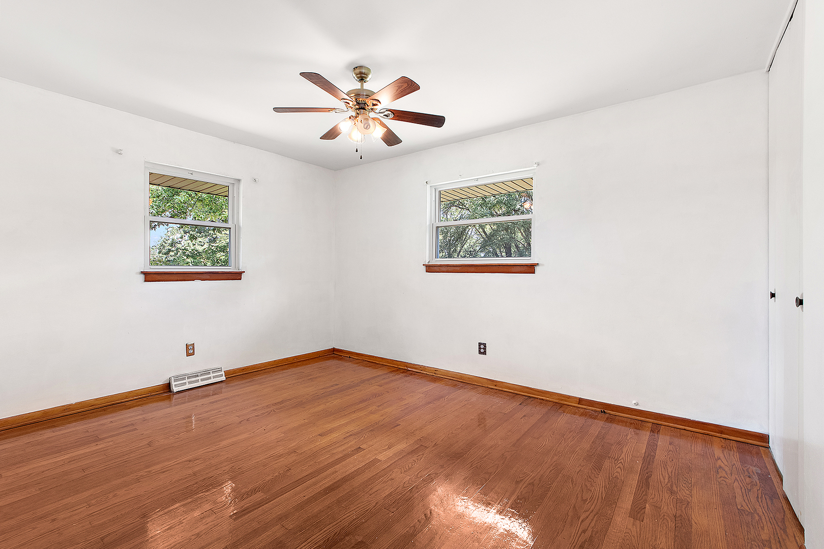 1400 Eunice Avenue Joliet, IL 60433 - Photo 9 of 34 a view of an empty room with chandelier fan and wooden floor