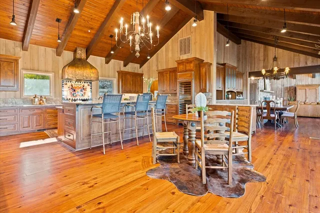 a view of a kitchen with a table and chairs