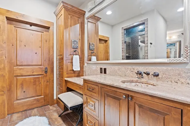 a bed sitting in a spacious bedroom next to a window