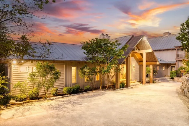 a living room with furniture a fireplace and a chandelier