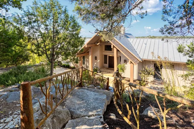 a living room with fireplace furniture and a large window