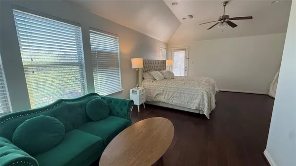 a bedroom with a bed a desk and chair