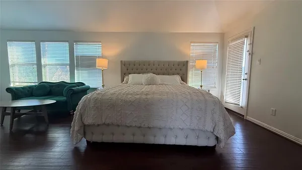a bedroom with a bed window and a chair