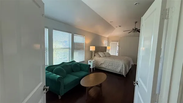 a bed sitting in a bedroom next to a window