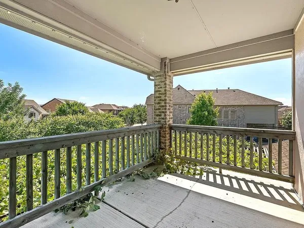 a view of a porch with wooden floor