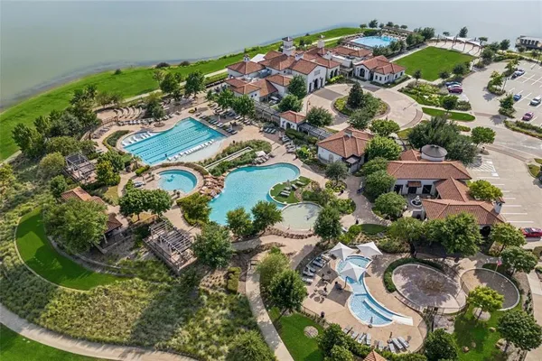 a view of a lake with a table and chairs under an umbrella