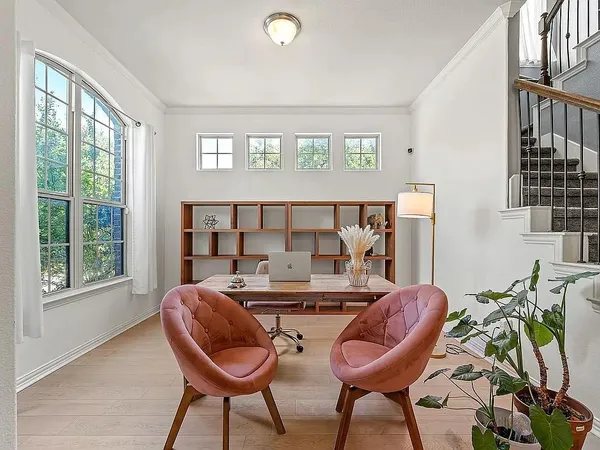 a view of a livingroom with furniture and a large window