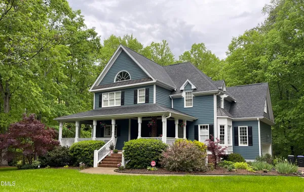 a front view of house with yard and green space