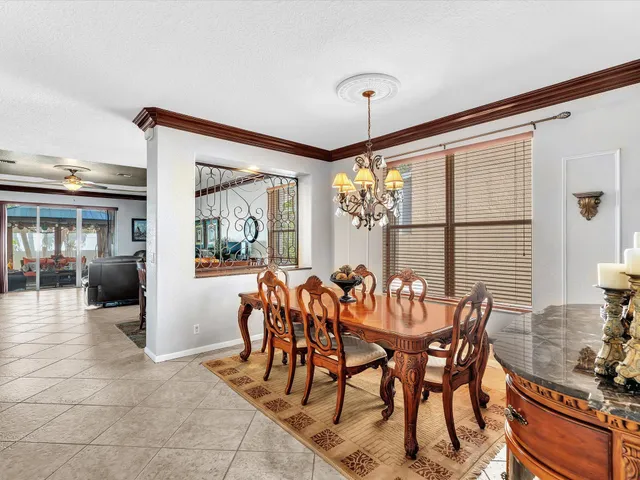 a view of a dining room and livingroom with furniture window and wooden floor