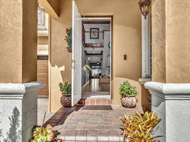 a living room with furniture a clock and a chandelier