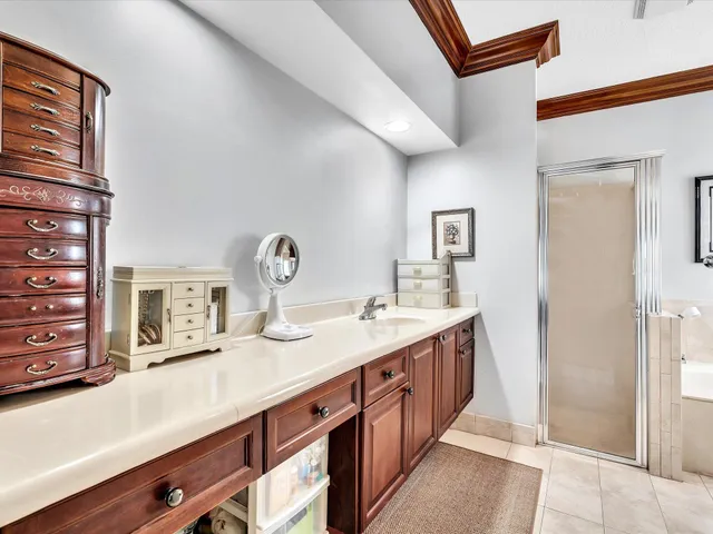 an aerial view of a house with swimming pool and large trees