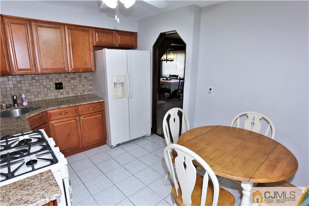 61 Ashley Road Edison, NJ 08817 - Photo 11 of 25 a kitchen with stainless steel appliances granite countertop a stove a sink and a refrigerator