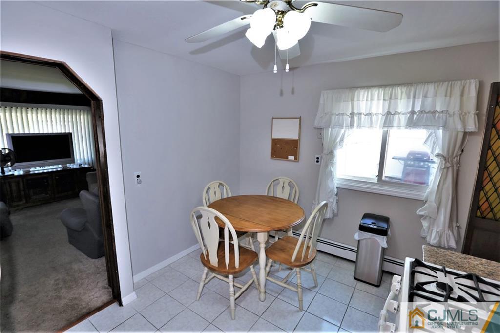 61 Ashley Road Edison, NJ 08817 - Photo 12 of 25 a view of a dining room with furniture and chandelier