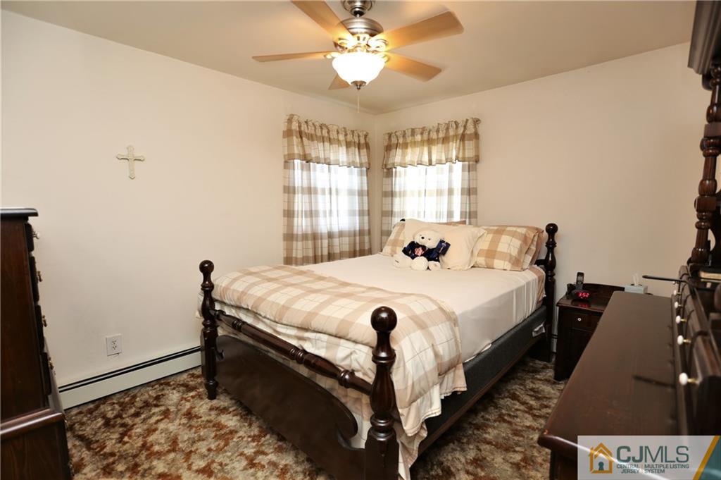 61 Ashley Road Edison, NJ 08817 - Photo 15 of 25 a bed sitting in a bedroom next to a window