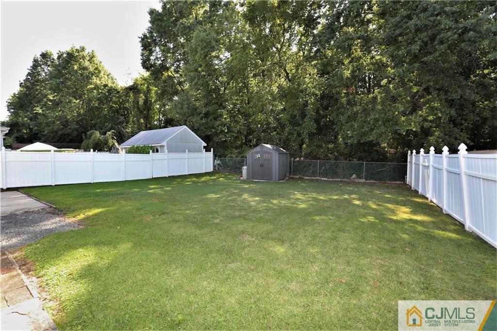 61 Ashley Road Edison, NJ 08817 - Photo 22 of 25 a view of a backyard with a small cabin
