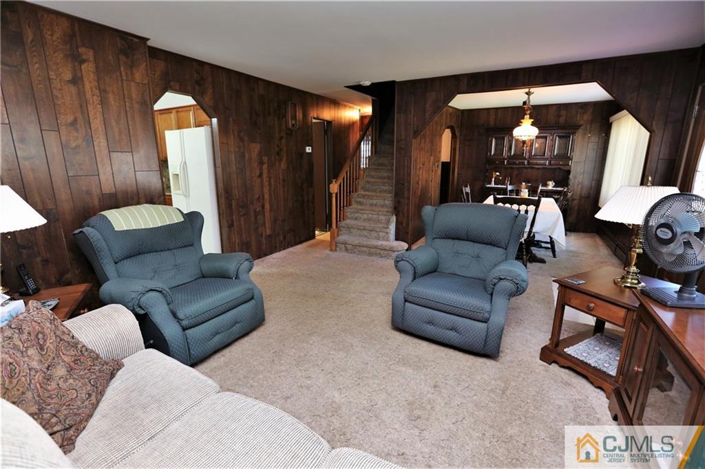 61 Ashley Road Edison, NJ 08817 - Photo 5 of 25 a living room with furniture and a mirror
