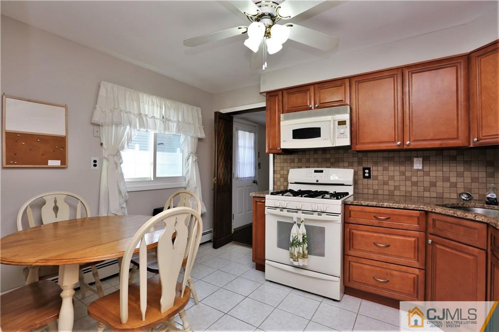 61 Ashley Road Edison, NJ 08817 - Photo 9 of 25 a kitchen with stainless steel appliances granite countertop a stove microwave and cabinets
