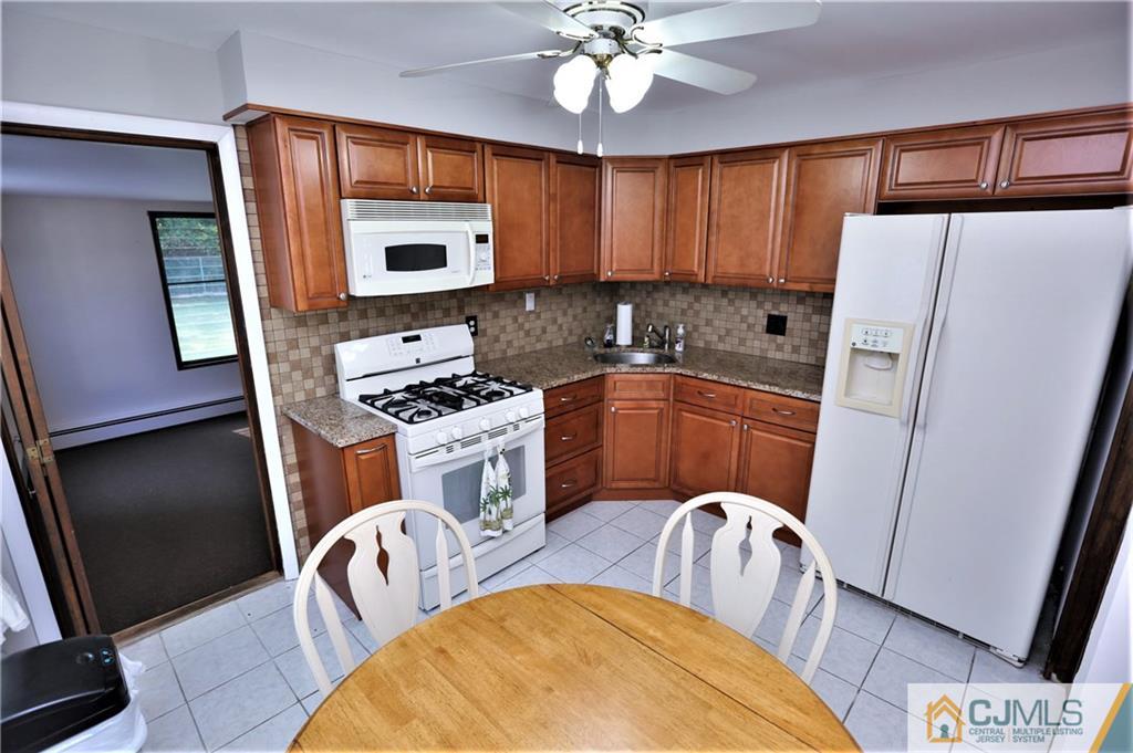61 Ashley Road Edison, NJ 08817 - Photo 10 of 25 a kitchen with stainless steel appliances granite countertop a refrigerator sink and stove