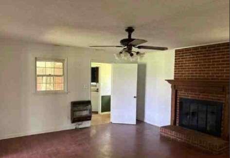1190 Asphalt Rock Road Cherokee, AL 35616 - Photo 6 of 13 a view of empty room with fireplace and wooden floor